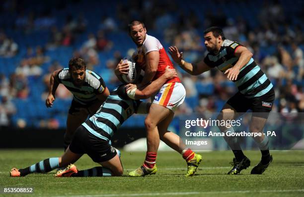 Catalan Dragons' Jason Baitieri is tackled by London Broncos' Nick Slyney and Matt Cook during the First Utility Super League Magic Weekend match at...