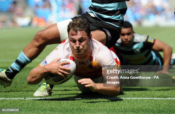 Catalan Dragons' Elliott Whitehead dives over to score a try during the First Utility Super League Magic Weekend match at the Etihad Stadium,...