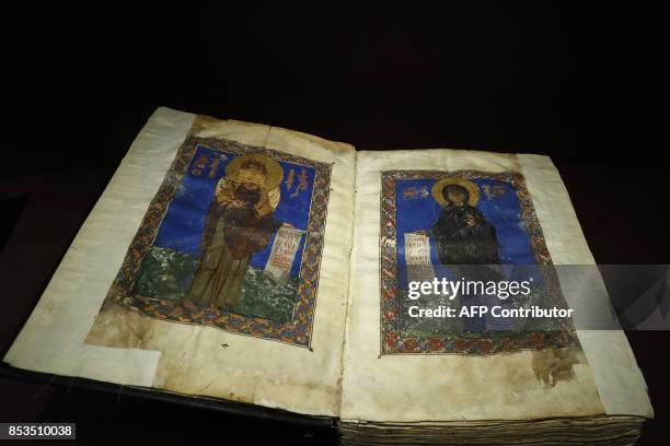This photo taken on September 25, 2017 at the Arab World Institute in Paris shows a religious codex originating from Syria during a press...
