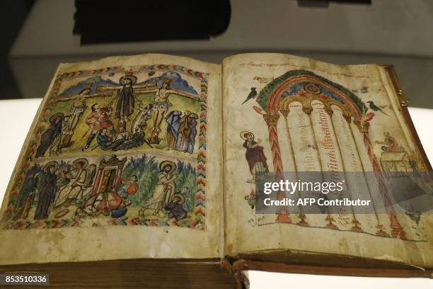 This photo taken on September 25, 2017 at the Arab World Institute in Paris shows a religious codex originating from Rabbula in Syria during a press...