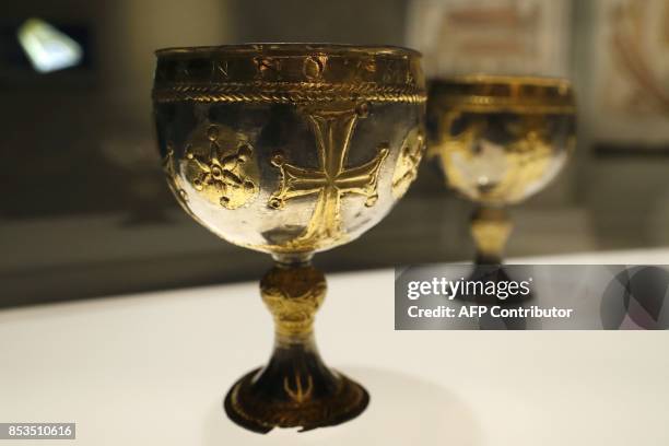 This photo taken on September 25, 2017 at the Arab World Institute in Paris shows a chalice originating from Attarouthi in Syria during a press...