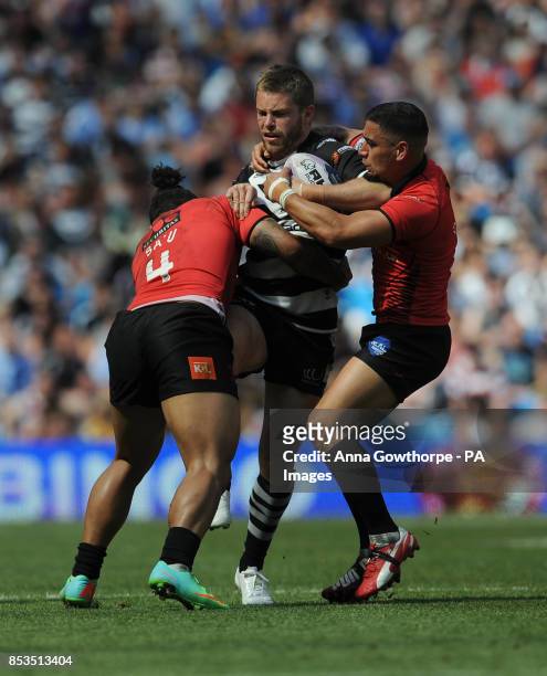 Widnes Vikings' Rhys Hanbury is tackled by Salford Red Devils' Junior Sa'u and Rangi Chase during the First Utility Super League Magic Weekend match...