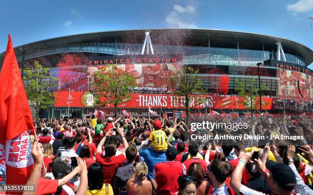 Arsenal players pose with the FA Cup outside the Emirates Stadium during the FA Cup winners parade in London.