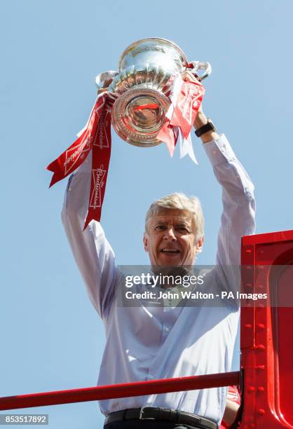 Arsenal manager Arsene Wenger celebrates with the trophy during the FA Cup winners parade at Islington Town Hall, London.