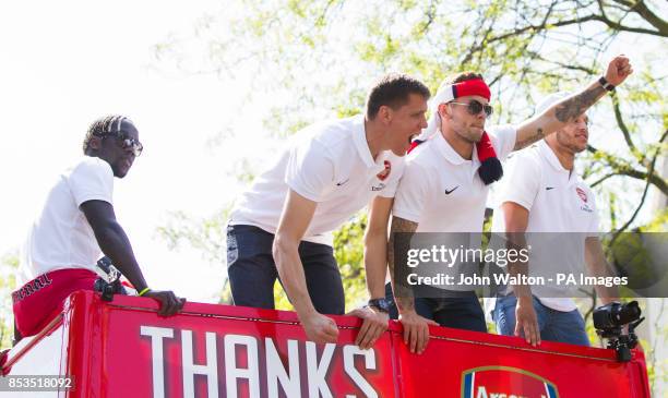 Arsenal's Wojciech Szczesny and Arsenal's Jack Wilshere celebrate on the victory parade during the FA Cup winners parade at Islington Town Hall,...