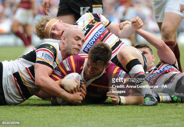 Huddersfield Giants' Anthony Mullally beats a trio of Bradford Bulls' players to score a try during the First Utility Super League Magic Weekend...
