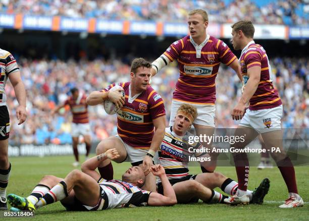 Huddersfield Giants' Anthony Mullally is congratulated by teammates after scoring a try during the First Utility Super League Magic Weekend match at...