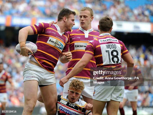 Huddersfield Giants' Anthony Mullally is congratulated by teammates after scoring a try during the First Utility Super League Magic Weekend match at...