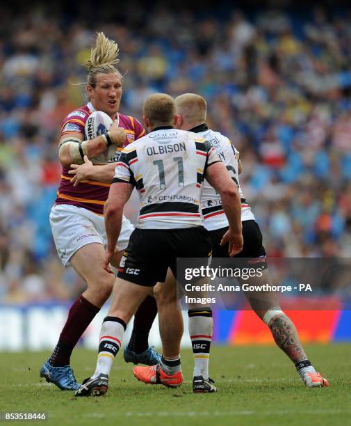 Huddersfield Giants' Eorl Crabtree is tackled by Bradford Bulls' Tom Olbison and Danny Addy during the First Utility Super League Magic Weekend match...