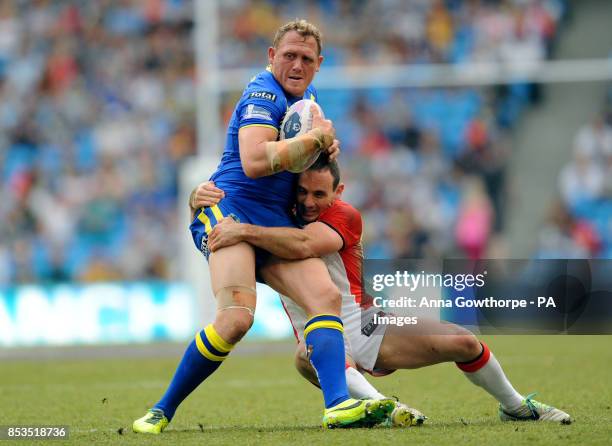 Warrington Wolves' Ben Westwood is tackled by St Helens' Lance Hohaia during the First Utility Super League Magic Weekend match at the Etihad...