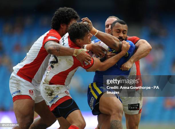 Warrington Wolves' Roy Asotasi is held bythe St Helens' defence during the First Utility Super League Magic Weekend match at the Etihad Stadium,...