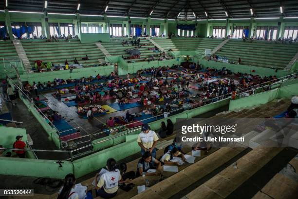 People are seen at evacuation center on September 25, 2017 in Klungkung regency, Island of Bali, Indonesia. Indonesian authorities raised the alert...