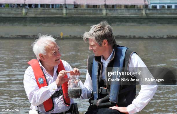 Zac Goldsmith MP joins Andrew Kerr Chairman of the Sustainable Eel Group as they release 10,000 juvenile eels into the River Thames from a boat in...