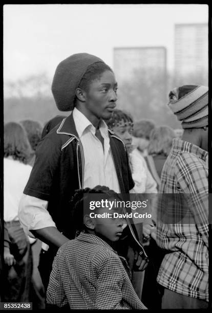 Photo of REGGAE; Rastafarian fan with young child