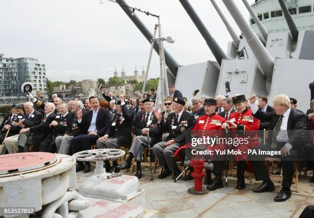 Prime Minister David Cameron and Mayor of London Boris Johnson giving three cheers with D-Day Veterans on board the Second World War warship HMS...