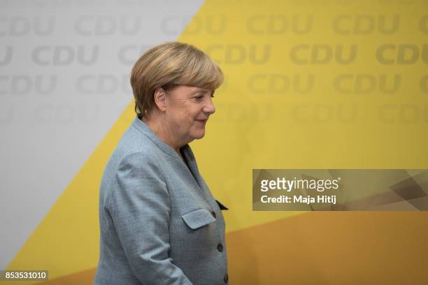 German Chancellor and Christian Democrat Angela Merkel leaves after giving statement to the media the day after the CDU won 32.9% of the vote and a...