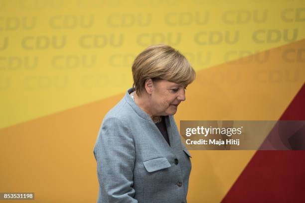 German Chancellor and Christian Democrat Angela Merkel leaves after giving statement to the media the day after the CDU won 32.9% of the vote and a...