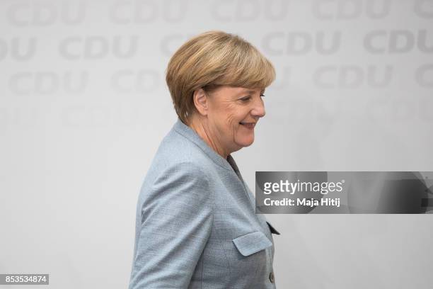 German Chancellor and Christian Democrat Angela Merkel leaves after giving statement to the media the day after the CDU won 32.9% of the vote and a...
