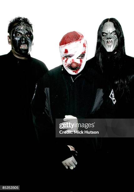 Photo of SLIPKNOT and Shawn CRAHAN and Mick THOMSON and Paul GRAY; L-R: Paul Gray, Shawn "Clown" Crahan, Mick Thomson - posed, studio