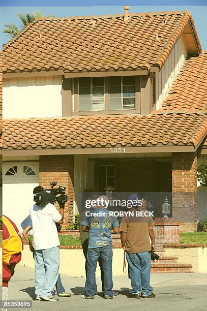 Crews and photographers wait in front of the new house of Nadya Suleman, mother of octuplets born earlier this year, March 10, 2009 in La Habra,...