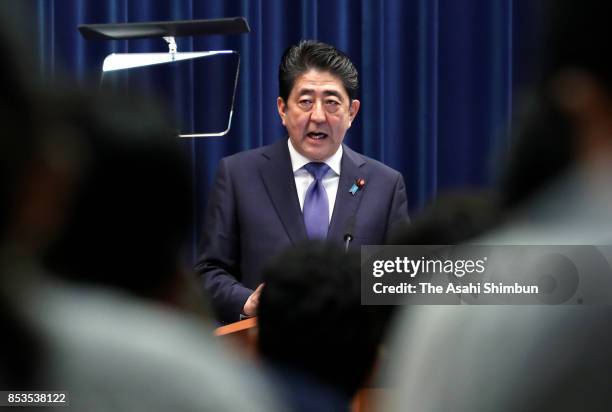 Prime Minister Shinzo Abe announces his intention to dissolve the Lower House when it convenes on September 28 during a press conference at his...