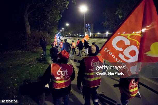 Lorry drivers from the French workers' union CGT block access roads to the Gennevilliers port, outside Paris, early on September 25 at the start of a...