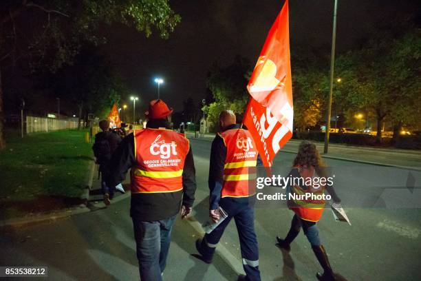 Lorry drivers from the French workers' union CGT block access roads to the Gennevilliers port, outside Paris, early on September 25 at the start of a...