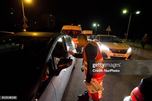 Lorry drivers from the French workers' union CGT block access roads to the Gennevilliers port, outside Paris, early on September 25 at the start of a...