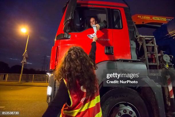 Lorry drivers from the French workers' union CGT block access roads to the Gennevilliers port, outside Paris, early on September 25 at the start of a...