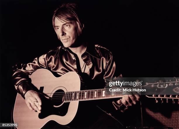 Photo of Paul WELLER; Posed portrait of Paul Weller, with acoustic guitar