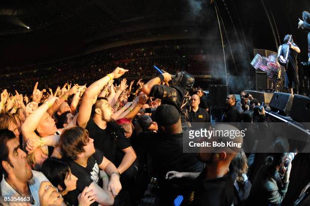 Photo of SLIPKNOT and Chris FEHN, Chris Fehn performing on stage, audience