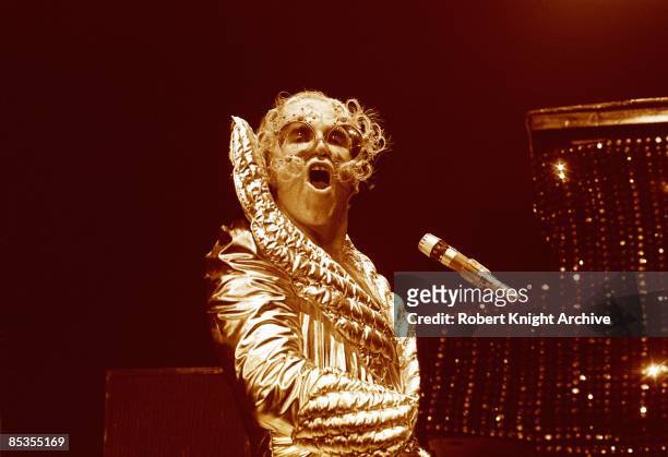 Elton John performing on stage in a shiny costume at Hawaii International Center, Honolulu, Hawaii, United States, October 1974.