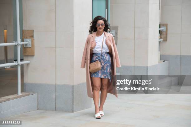 Fashion blogger Roxie Nafousi wears Moncler sunglasses, Gucci bag, New Look jacket and shoes and a Never fully dressed skirt and top on day 1 of...