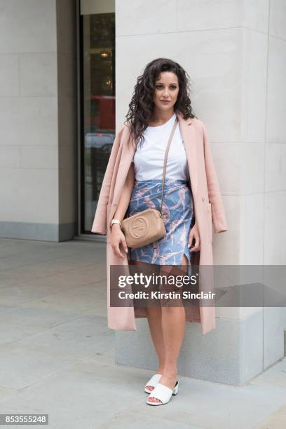 Fashion blogger Roxie Nafousi wears Moncler sunglasses, Gucci bag, New Look jacket and shoes and a Never fully dressed skirt and top on day 1 of...