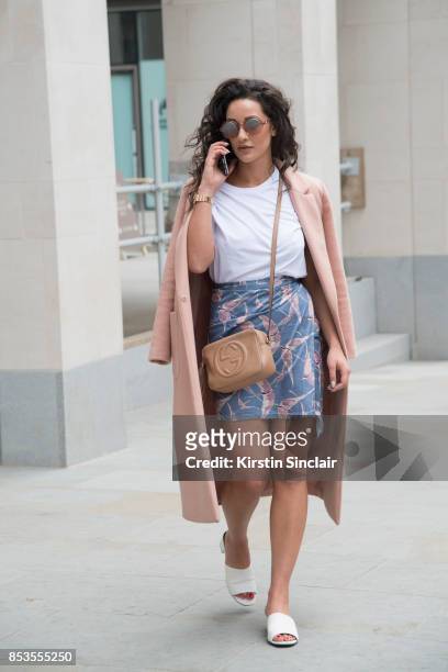 Fashion blogger Roxie Nafousi wears Moncler sunglasses, Gucci bag, New Look jacket and shoes and a Never fully dressed skirt and top on day 1 of...
