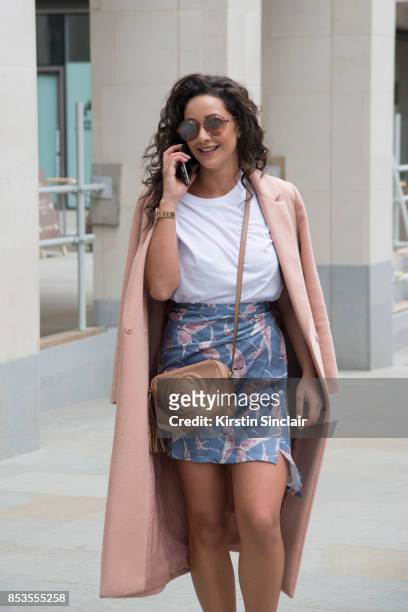 Fashion blogger Roxie Nafousi wears Moncler sunglasses, Gucci bag, New Look jacket and a Never fully dressed skirt and top on day 1 of London Womens...