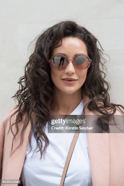 Fashion blogger Roxie Nafousi wears Moncler sunglasses, New Look jacket and a Never fully dressed top on day 1 of London Womens Fashion Week...