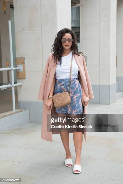 Fashion blogger Roxie Nafousi wears Moncler sunglasses, Gucci bag, New Look jacket and shoes and a Never fully dressed skirt and top on day 1 of...