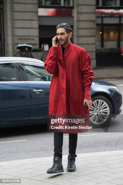 Guest wears a red jacket on day 1 of London Womens Fashion Week Spring/Summer 2018, on September 15, 2017 in London, England.