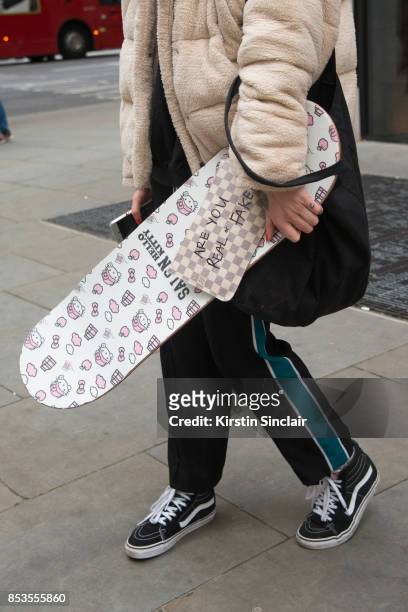 Model and skateboarder Stephani Nurding wears Vans trainers, Kenzo trousers, Louis Vuitton bag, Urban Outfitters jacket and her own brand skateboard...