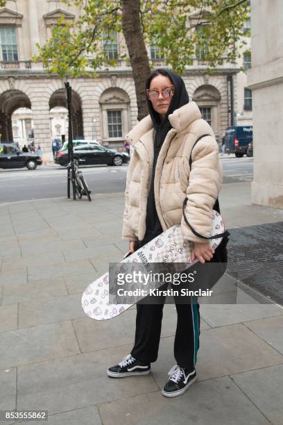 Model and skateboarder Stephani Nurding wears Vans trainers, Kenzo trousers, Louis Vuitton bag, Urban Outfitters jacket, Alien sunglasses and her own...