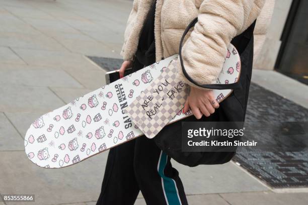 Model and skateboarder Stephani Nurding wears a Louis Vuitton bag, Kenzo trousers, Urban Outfitters jacket and her own brand skateboard Salon on day...