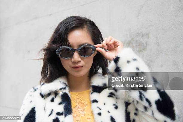 Model and Actress Betty Bachz wears a Shrimps coat and dress and Moy Atelier sunglasses on day 1 of London Womens Fashion Week Spring/Summer 2018, on...