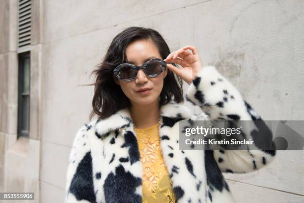 Model and Actress Betty Bachz wears a Shrimps coat and dress and Moy Atelier sunglasses on day 1 of London Womens Fashion Week Spring/Summer 2018, on...