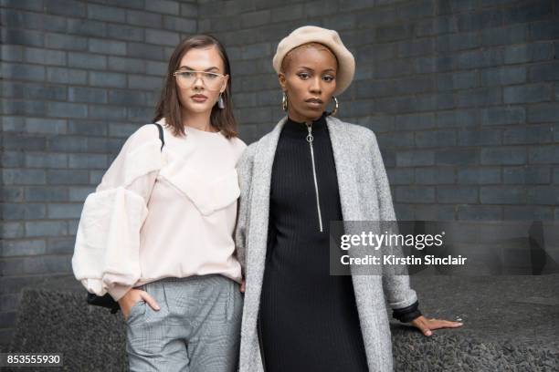 Fashion blogger Klaudia Wieteska wears a Zara top, Muse Me glasses and New Look trousers with Fashion blogger Irene Iredia wearing a Miss Guided...