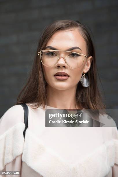 Fashion blogger Klaudia Wieteska wears a Zara top, Muse Me glasses on day 1 of London Womens Fashion Week Spring/Summer 2018, on September 15, 2017...