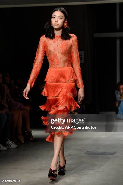 Model presents a creation for fashion house Daizy Shely during the Women's Spring/Summer 2018 fashion shows in Milan, on September 25, 2017. / AFP...