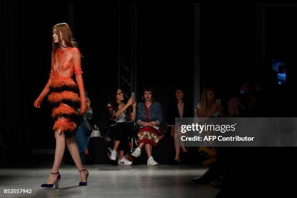 Model presents a creation for fashion house Daizy Shely during the Women's Spring/Summer 2018 fashion shows in Milan, on September 25, 2017. / AFP...