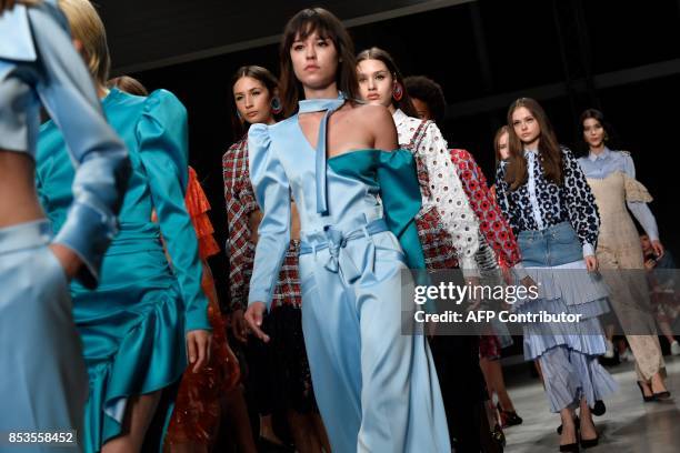 Models present creations for fashion house Daizy Shely during the Women's Spring/Summer 2018 fashion shows in Milan, on September 25, 2017. / AFP...