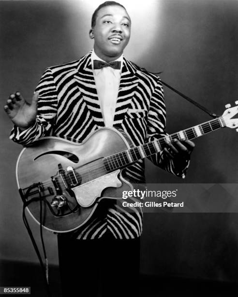 Photo of JB LENOIR; Posed studio portrait of JB Lenoir with guitar